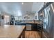 Open kitchen featuring stainless steel appliances, dark wood cabinetry, and center island at 5924 W Shangri La Rd, Glendale, AZ 85304