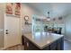 Bright kitchen featuring an island with dining area and backyard views through the large windows at 5924 W Shangri La Rd, Glendale, AZ 85304