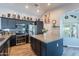 Modern kitchen featuring dark cabinets, stainless steel appliances, and a spacious center island at 5924 W Shangri La Rd, Glendale, AZ 85304