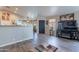 Open-concept living space with dark front door, a view of the dining area, and durable wood-look floors at 5924 W Shangri La Rd, Glendale, AZ 85304