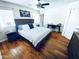Cozy bedroom features hardwood floors, a large bed, and a functional workspace at 6920 E Beverly Ln, Scottsdale, AZ 85254
