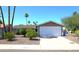 Inviting single-story home with a neatly landscaped front yard and a two-car garage at 6920 E Beverly Ln, Scottsdale, AZ 85254