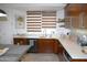 Stylish kitchen with wood cabinets, quartz counters, and modern backsplash at 6920 E Beverly Ln, Scottsdale, AZ 85254