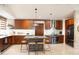 Modern kitchen with stainless steel appliances, a central island, and ample cabinet space at 6920 E Beverly Ln, Scottsdale, AZ 85254