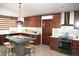 Spacious kitchen with wood cabinets, a center island, and stainless steel appliances at 6920 E Beverly Ln, Scottsdale, AZ 85254