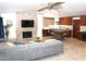 Open-concept living room features a stone fireplace, vaulted ceilings, and seamless flow into the kitchen at 6920 E Beverly Ln, Scottsdale, AZ 85254