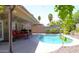 Outdoor area featuring a blue swimming pool, lounge seating, and lush desert landscaping at 6920 E Beverly Ln, Scottsdale, AZ 85254
