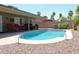 Backyard showcasing a refreshing pool, covered patio with seating, and desert landscaping at 6920 E Beverly Ln, Scottsdale, AZ 85254