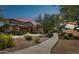 Charming single-Gathering home with desert landscaping, private garage, and well-lit entrance at sunset at 7221 E Eclipse Dr, Scottsdale, AZ 85266