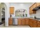 Charming kitchen with tan countertops and wood cabinets with an open view to the adjacent living area at 7221 E Eclipse Dr, Scottsdale, AZ 85266