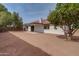 A spacious backyard featuring a covered patio, a large tree, and a white stucco exterior at 743 N Bermuda --, Mesa, AZ 85205