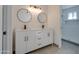 Modern bathroom with a double sink vanity, round mirrors, and updated fixtures at 743 N Bermuda --, Mesa, AZ 85205