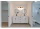 Modern bathroom with a double sink vanity, round mirrors, and updated fixtures at 743 N Bermuda --, Mesa, AZ 85205