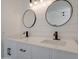 Close-up of modern bathroom vanity with dual sinks, round mirrors, and dark hardware at 743 N Bermuda --, Mesa, AZ 85205