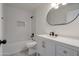 Stylish white bathroom featuring an oval mirror, modern vanity, and tiled shower/tub at 743 N Bermuda --, Mesa, AZ 85205