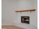 Close-up of the fireplace with wooden mantle and painted white brick at 743 N Bermuda --, Mesa, AZ 85205