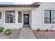 This image showcases the front entrance with its black front door and well-maintained landscaping at 743 N Bermuda --, Mesa, AZ 85205