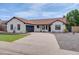 Single-story home featuring a neutral exterior paint, a well-manicured lawn, and a concrete driveway at 743 N Bermuda --, Mesa, AZ 85205
