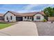 Single-story home featuring a neutral exterior paint, a well-manicured lawn, and a concrete driveway at 743 N Bermuda --, Mesa, AZ 85205