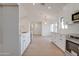Bright kitchen featuring white cabinets, stainless steel appliances, and light wood flooring at 743 N Bermuda --, Mesa, AZ 85205