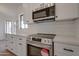 Stainless steel appliances and white cabinetry in this well-lit, modern kitchen at 743 N Bermuda --, Mesa, AZ 85205