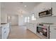 Bright kitchen showcasing stainless steel appliances, shaker cabinets, and abundant natural light at 743 N Bermuda --, Mesa, AZ 85205