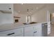 Close-up on the kitchen, highlighting the countertops, stainless steel sink, and white cabinetry at 743 N Bermuda --, Mesa, AZ 85205