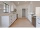 Bright white kitchen with stainless appliances, quartz countertops, and modern finishes at 743 N Bermuda --, Mesa, AZ 85205