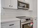 Close up of stainless steel oven and microwave above quartz countertops with black hardware at 743 N Bermuda --, Mesa, AZ 85205
