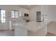 Kitchen island featuring white quartz countertops, stainless steel sink, and black hardware at 743 N Bermuda --, Mesa, AZ 85205