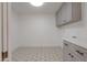 Neat laundry room features patterned flooring, gray cabinets, and ample space at 743 N Bermuda --, Mesa, AZ 85205