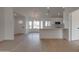 Bright open floor plan with kitchen island, white cabinets, and modern light fixture at 743 N Bermuda --, Mesa, AZ 85205