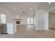 Bright living room and kitchen area featuring neutral walls and floors, modern lighting, and white cabinets at 743 N Bermuda --, Mesa, AZ 85205