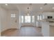 Bright living room and kitchen area featuring neutral walls and floors, modern lighting, and white cabinets at 743 N Bermuda --, Mesa, AZ 85205