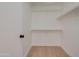 Walk-in closet features built in shelving and wood flooring at 743 N Bermuda --, Mesa, AZ 85205