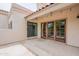 Charming back patio with classic design, terracotta roof, and wooden framed sliding glass doors at 7800 E Lincoln Dr # 2029, Scottsdale, AZ 85250