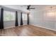 Serene bedroom showcases wood floors, decorative wall panels, pendant lights, and black-out curtains for enhanced ambiance at 7800 E Lincoln Dr # 2029, Scottsdale, AZ 85250