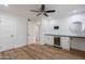 Bedroom with a bar featuring white cabinets, a wine cooler, and hardwood floors at 7800 E Lincoln Dr # 2029, Scottsdale, AZ 85250