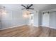 Bright bedroom features wood floors, panelled walls, barn doors, modern lighting and easy access to an ensuite bathroom at 7800 E Lincoln Dr # 2029, Scottsdale, AZ 85250