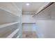 Walk-in closet with custom shelving and tile floors at 7800 E Lincoln Dr # 2029, Scottsdale, AZ 85250