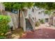 Inviting exterior view with a quaint patio, lush greenery, and textured walls giving curb appeal at 7800 E Lincoln Dr # 2029, Scottsdale, AZ 85250