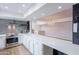 A bright kitchen featuring stainless steel appliances, white cabinetry, and an expansive island at 7800 E Lincoln Dr # 2029, Scottsdale, AZ 85250