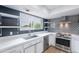 Modern kitchen showcasing white countertops, stainless steel appliances, and trendy backsplash and shelving at 7800 E Lincoln Dr # 2029, Scottsdale, AZ 85250