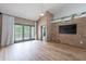Open living area with exposed brick walls, wood floors, vaulted ceilings, and a ceiling fan for a modern aesthetic at 7800 E Lincoln Dr # 2029, Scottsdale, AZ 85250