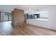 Spacious living room featuring hardwood floors and a view into a kitchen with modern appliances at 7800 E Lincoln Dr # 2029, Scottsdale, AZ 85250