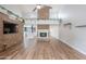 Cozy living room features wood floors, brick accents, a fireplace, loft area, and an open layout at 7800 E Lincoln Dr # 2029, Scottsdale, AZ 85250