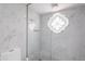 Bathroom featuring a glass enclosed shower with marble tile and a patterned window at 7800 E Lincoln Dr # 2029, Scottsdale, AZ 85250