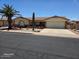 Charming single-story home featuring a well-maintained lawn and a desert-themed landscape with a palm tree at 8303 E Meseto Ave, Mesa, AZ 85209