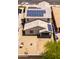 This backyard view shows a two-story home with solar panels and a low-maintenance gravel yard at 8924 N 102Nd Ln, Peoria, AZ 85345