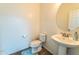 Powder room featuring pedestal sink, round mirror, and a toilet at 8924 N 102Nd Ln, Peoria, AZ 85345